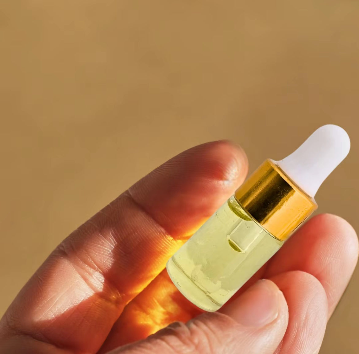 Applying Limitless Perfume Oil roll-on to wrist – gentle essential oil scent